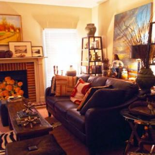 A cozy living room adorned with artwork and a warm atmosphere.
