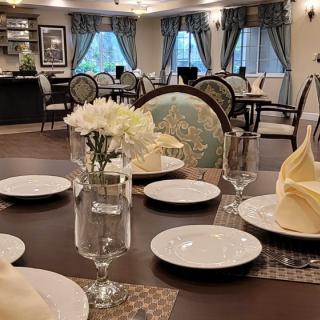 An elegantly set dining table in a well-decorated restaurant environment.
