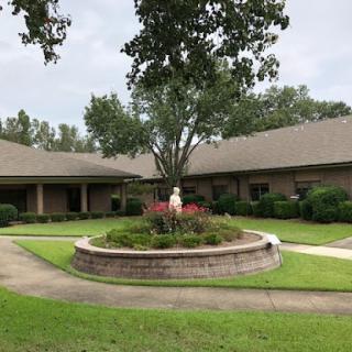 A serene residential setting featuring landscaped gardens and well-maintained pathways.