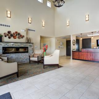 A modern lobby featuring a cozy sitting area with a fireplace and reception desk.