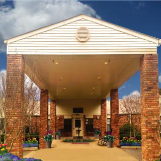 The welcoming entrance of a well-designed building, showcasing a combination of brick and modern architecture.