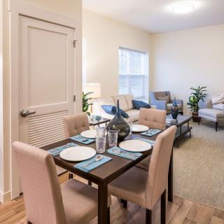 A modern open-plan dining and living area with stylish furnishings and decor.