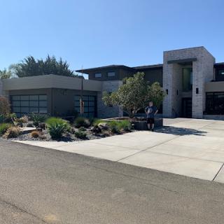 A modern residential home featuring contemporary design and well-maintained landscaping.