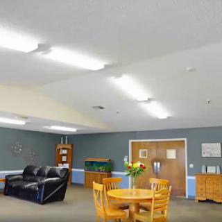 A cozy lounge area featuring comfortable seating and a dining table.