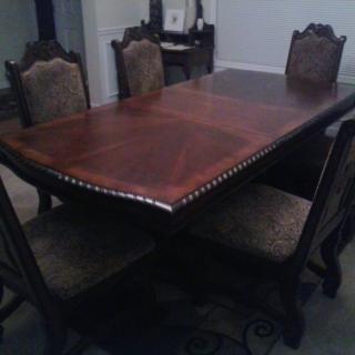 A classic wooden dining table set with four chairs.