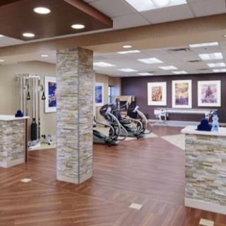A modern, well-lit fitness center with exercise equipment and elegant interior design.