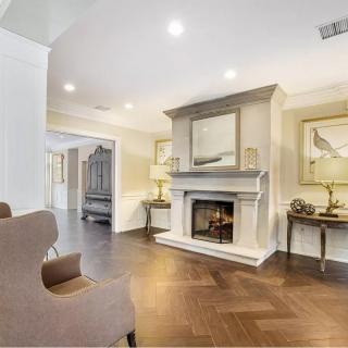 A cozy living room with a fireplace and elegant interior design.