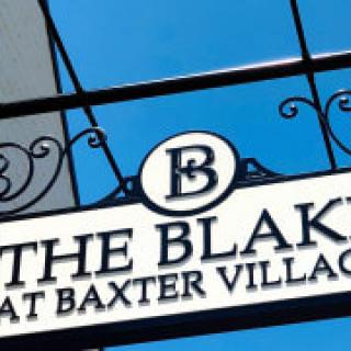 Sign for The Blakeney at Baxter Village featuring decorative wrought iron detailing.