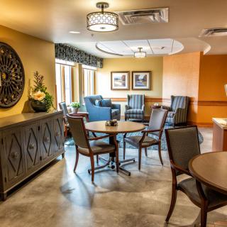 A cozy lounge area with comfortable seating, decorative elements, and warm lighting.