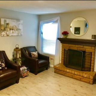 Cozy living room with comfortable armchairs and a brick fireplace.