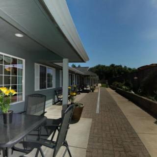 A modern outdoor patio area with seating and a view of the surrounding landscape.