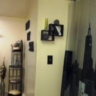 A cozy interior space featuring decorative wall shelves and artwork.
