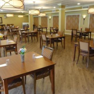 An empty dining room with neatly arranged tables and chairs.