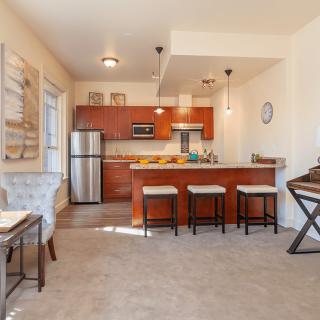 A modern open-plan kitchen and living area with stylish decor and contemporary appliances.