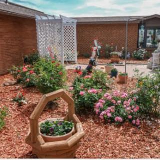 A beautifully landscaped garden featuring vibrant flowers, decorative planters, and a serene outdoor space.