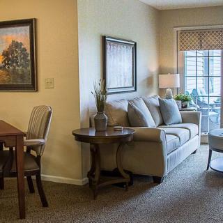 A cozy living room with modern decor and a dining area.