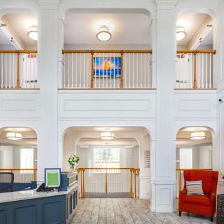A modern lobby interior with balconies and stylish lighting.