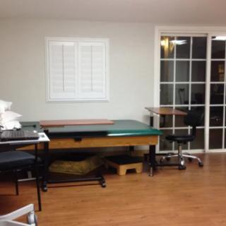 A therapy room with massage tables and medical equipment ready for use.