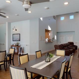 A modern dining and living area with stylish furniture and wood flooring.