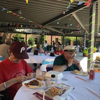 People enjoying a meal at an outdoor picnic.