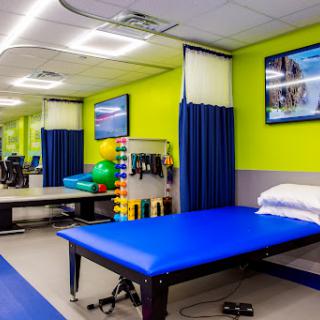 A vibrant physical therapy room equipped with exercise tools and treatment areas, designed to promote healing and rehabilitation.