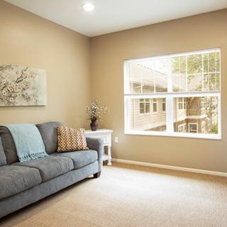 A cozy living room with a comfortable sofa and large window.