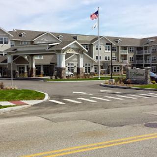A modern senior living facility featuring a welcoming entrance and landscaped surroundings.