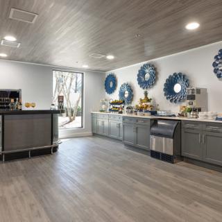 A modern kitchen with blue decor accents and a catering setup.