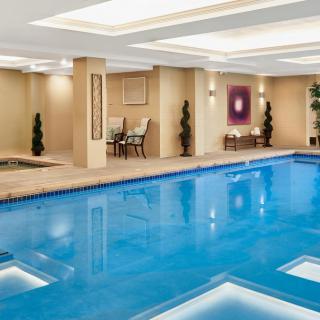 Luxurious indoor swimming pool with elegant decor and ambient lighting.