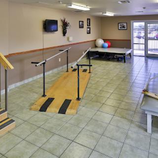 A physical therapy room equipped with walking aids and exercise equipment, designed for rehabilitation.