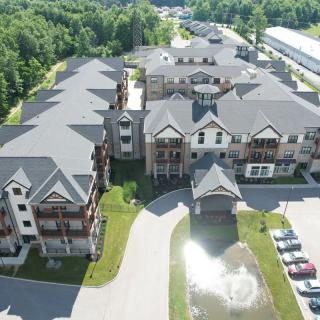 Aerial view of a modern apartment complex surrounded by greenery.