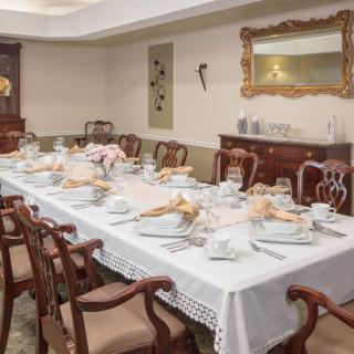 A beautifully set dining table in an elegant room, ready for a formal gathering.