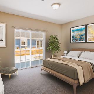 A modern bedroom with stylish decor, featuring a comfy bed, framed artwork, and a large window.