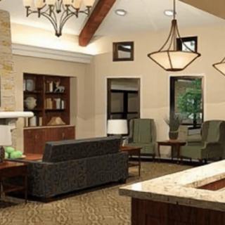 A cozy living room interior with modern furniture and elegant chandeliers.