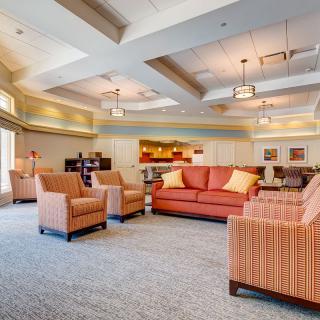 A spacious living room with comfortable seating and warm lighting.