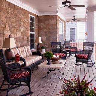 A cozy patio with wicker furniture and stylish decor.