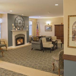 A cozy living room with a fireplace and seating area.