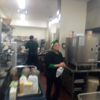 A busy kitchen with staff preparing food.