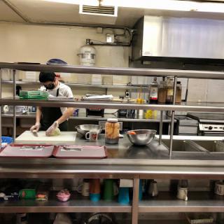 A chef busily preparing ingredients in a restaurant kitchen.