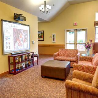 A cozy living room with comfortable seating and a large screen for entertainment.