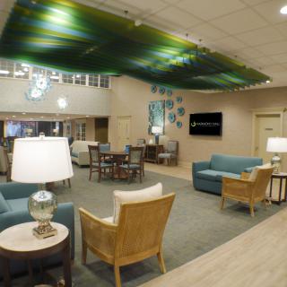 A modern lobby with comfortable seating and unique ceiling decor.