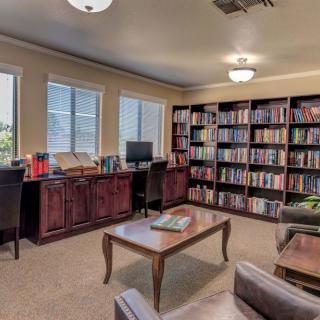 A cozy library with bookshelves and comfortable seating.