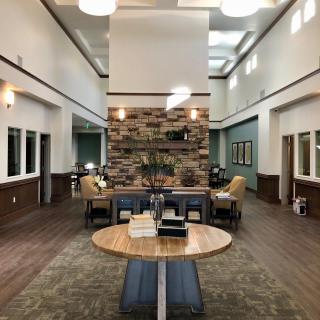 A modern lobby with stylish interior design, featuring comfortable seating and warm wood accents.