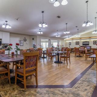 A spacious dining area with wooden furniture and ambient lighting.