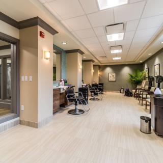 A modern salon interior with styling chairs and mirrors.