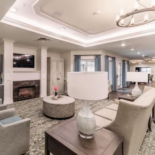A modern living room featuring elegant furnishings and a cozy fireplace.