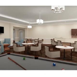 A spacious recreation room featuring a pool table and several tables with chairs, illuminated by modern lighting fixtures.