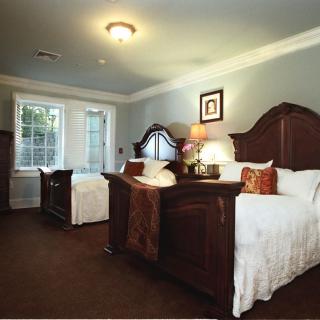 A cozy bedroom with two twin beds and warm decor.