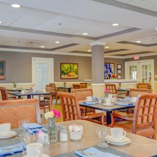 A well-appointed dining area with neatly set tables and comfortable seating.
