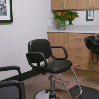 A modern hair salon featuring a styling chair and elegant decor.